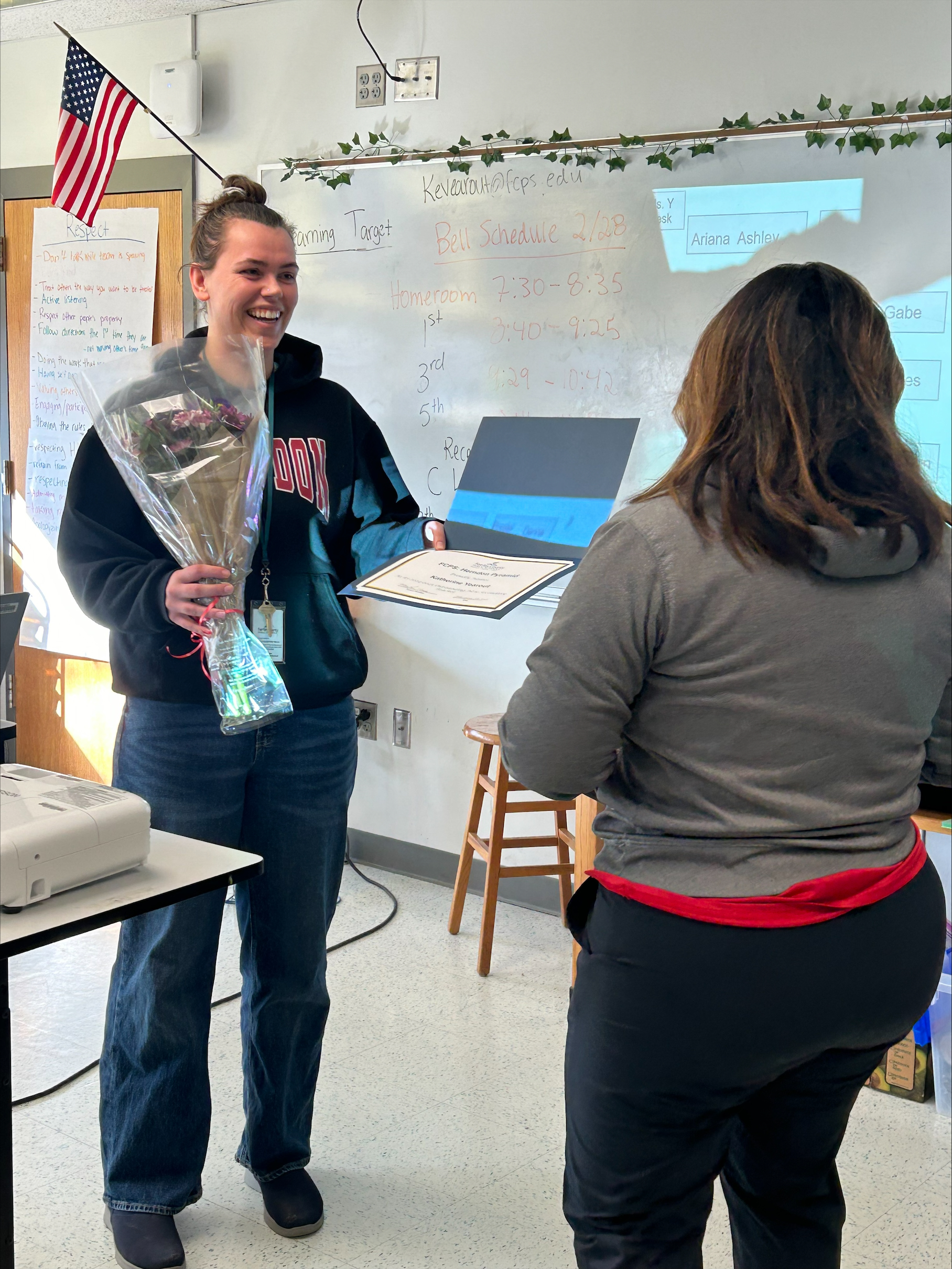 Katherine Yearout reciving her award and flowers from Principal Vereb